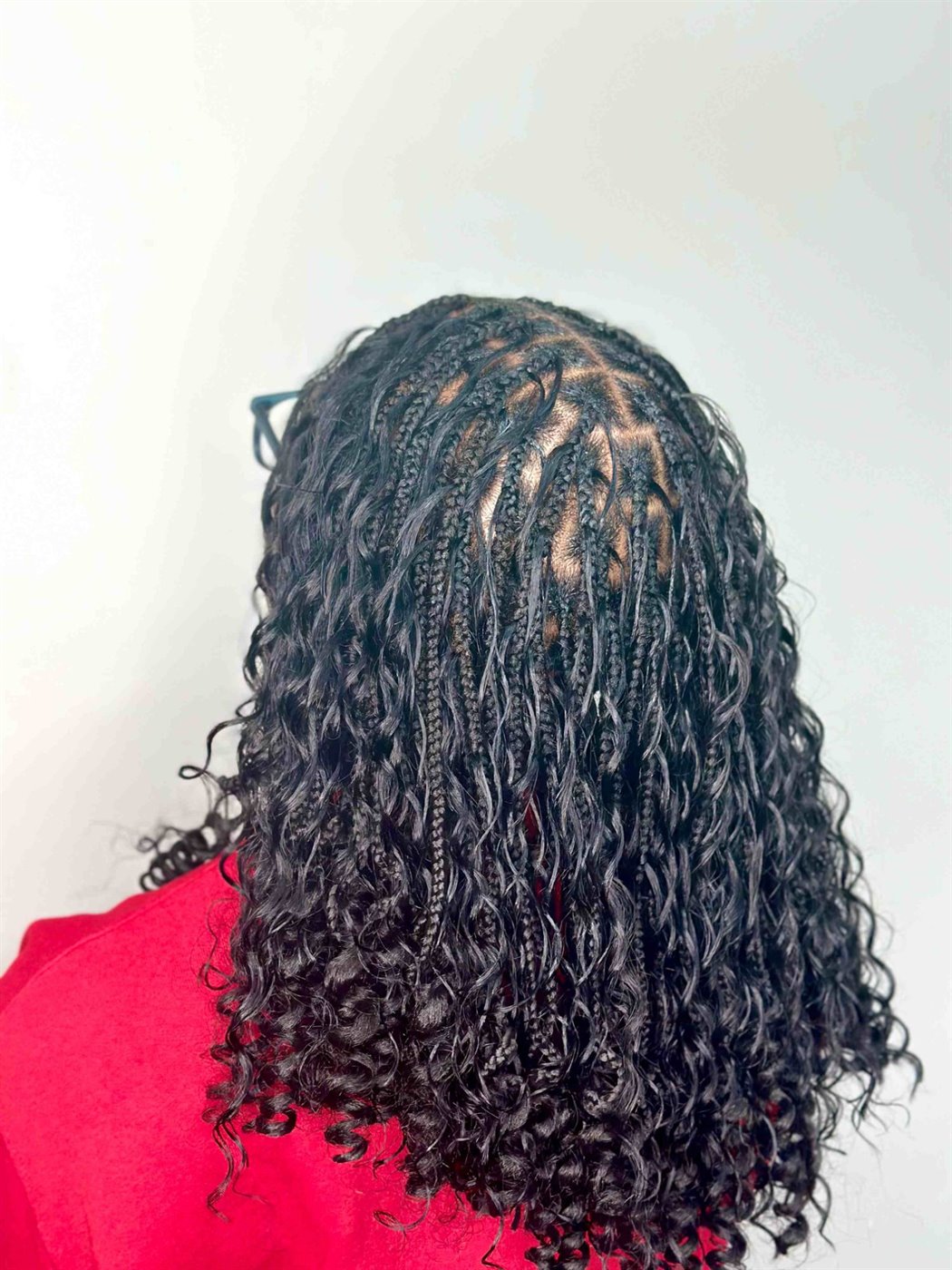 Natural black boho braids with curls left out, seen from above