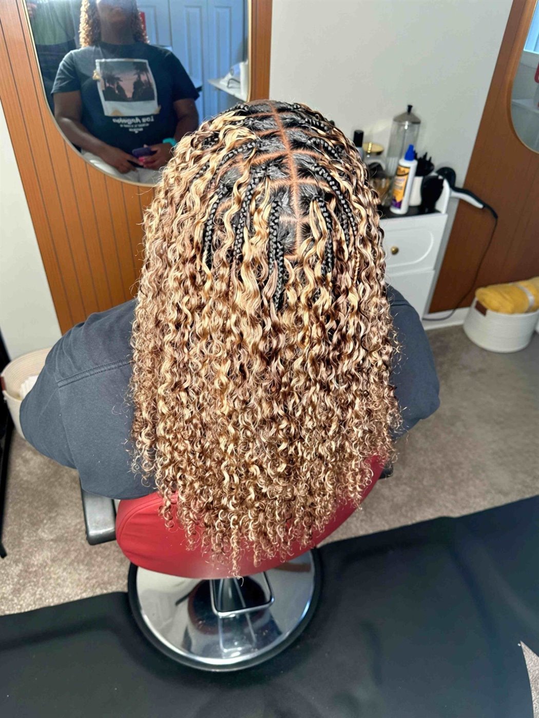 Honey-blonde Miracle braid from behind: square parts and short braids at the root, loose curls below