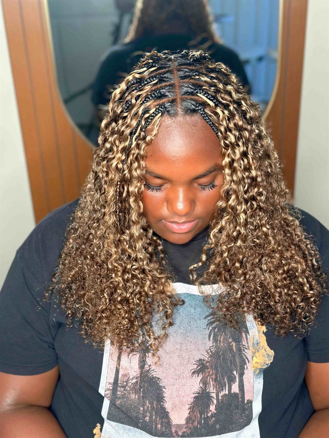 Honey-blonde Miracle knots seen from the front as the client looks down, showing the center part