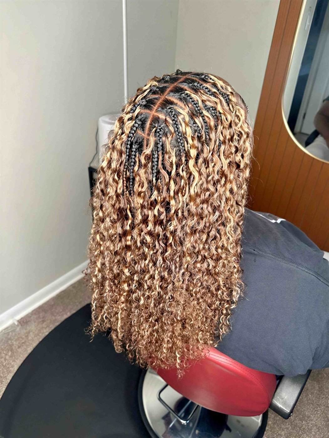 Honey-blonde Miracle knots from behind at an angle, curls reaching mid-back